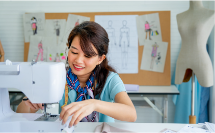 Smiling woman sewing on a sewing machine.